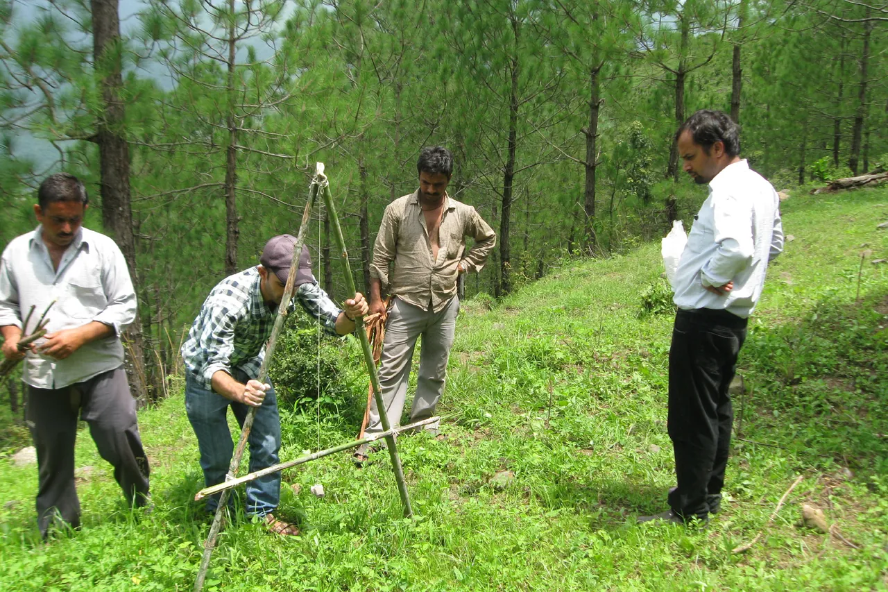 Villagers learn to measure slope and mark trenches with an A-frame for spring revival in Uttarakhand