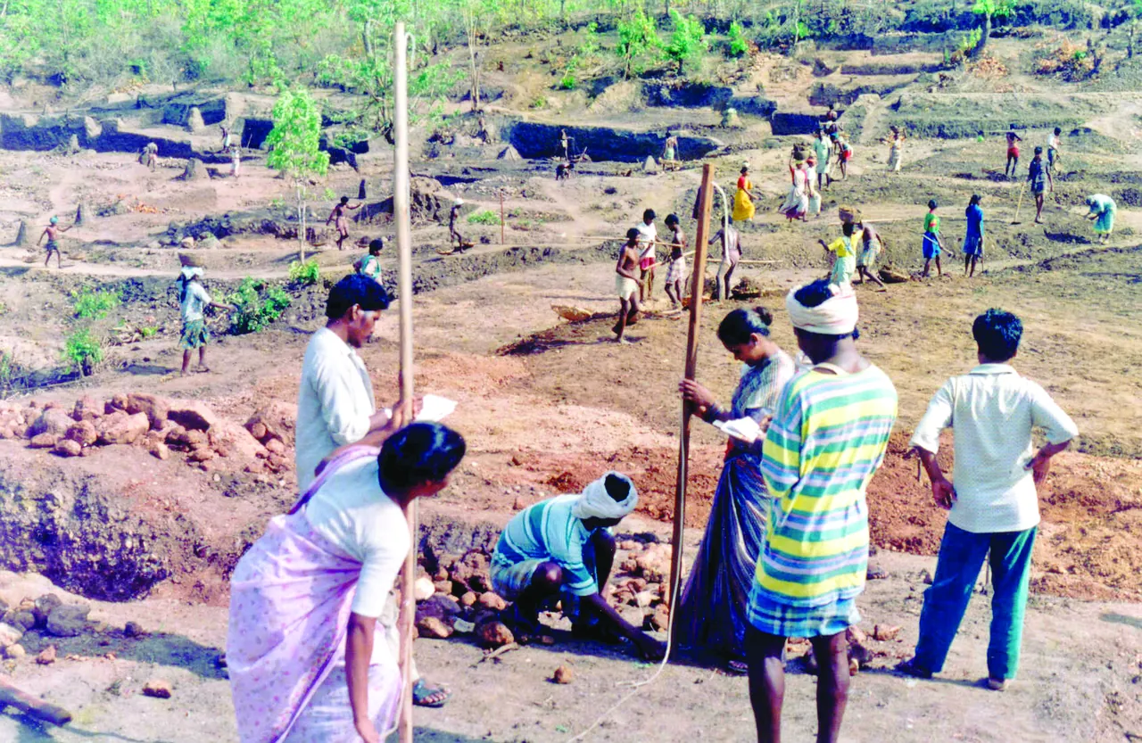 Villagers measure land with a pole during drought-proofing work in Palamu